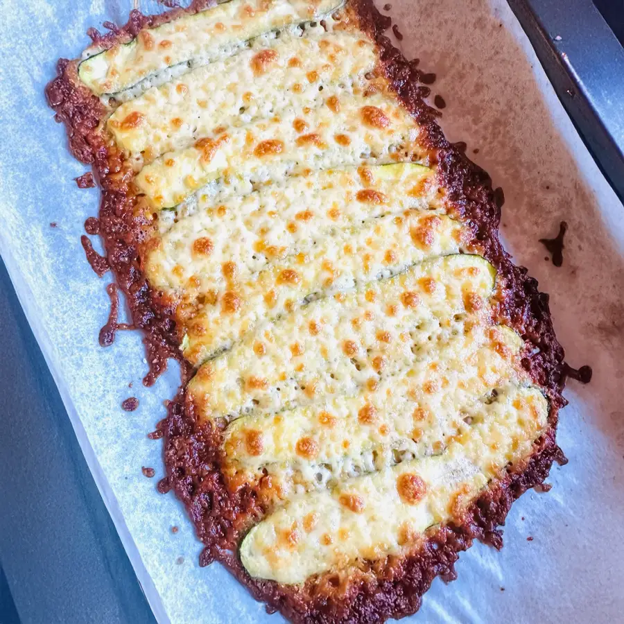 Golden-brown grilled zucchini planks on baking tray